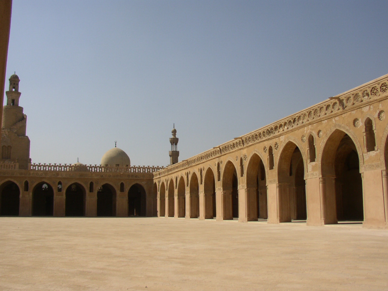 Quiet historic courtyard enclosed by stone buildings in Cairo
